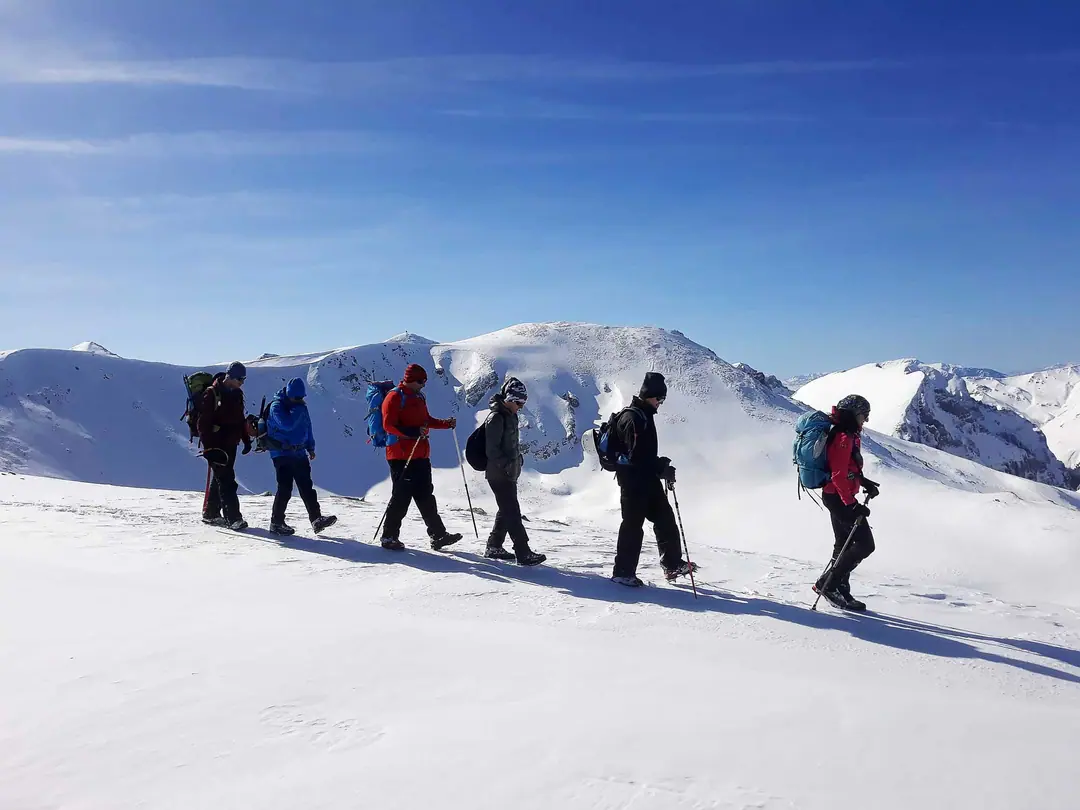 Winter hike across snowfields on a sunny day