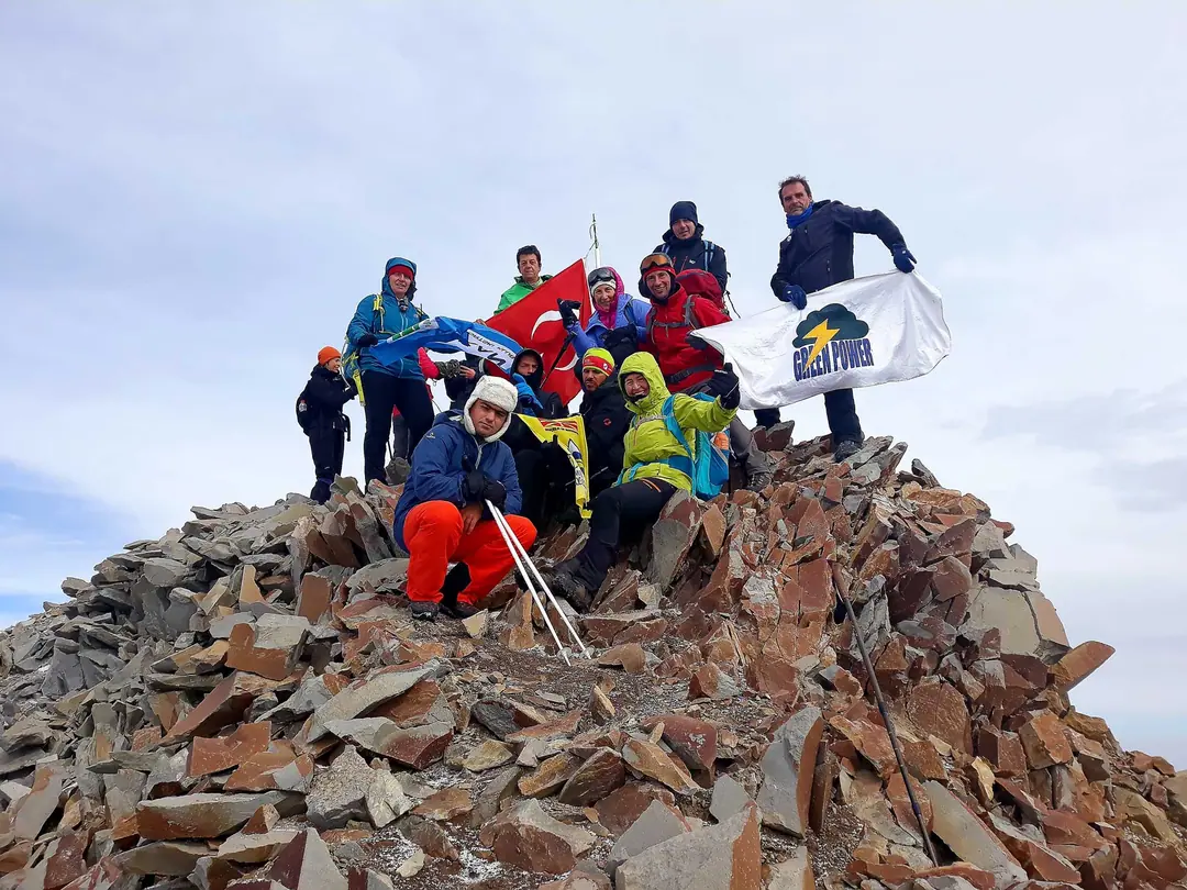 Hiking group celebrating on a rocky summit