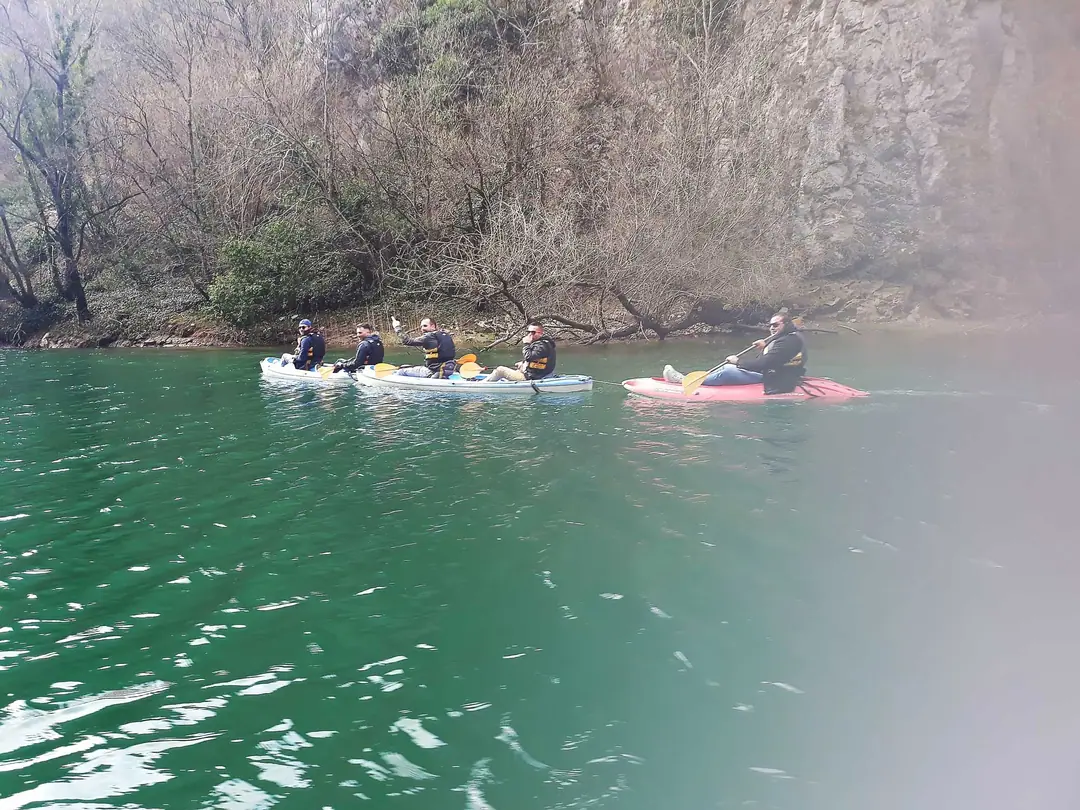 Group kayaking on the green water of Lake Matka